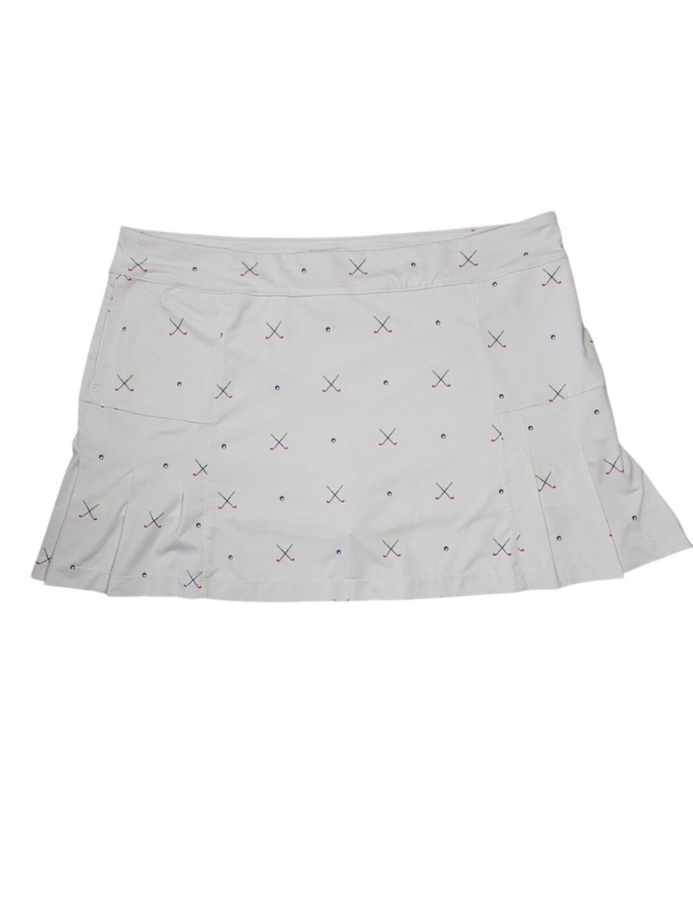 White pleated golf skirt with clubs and golf balls print.